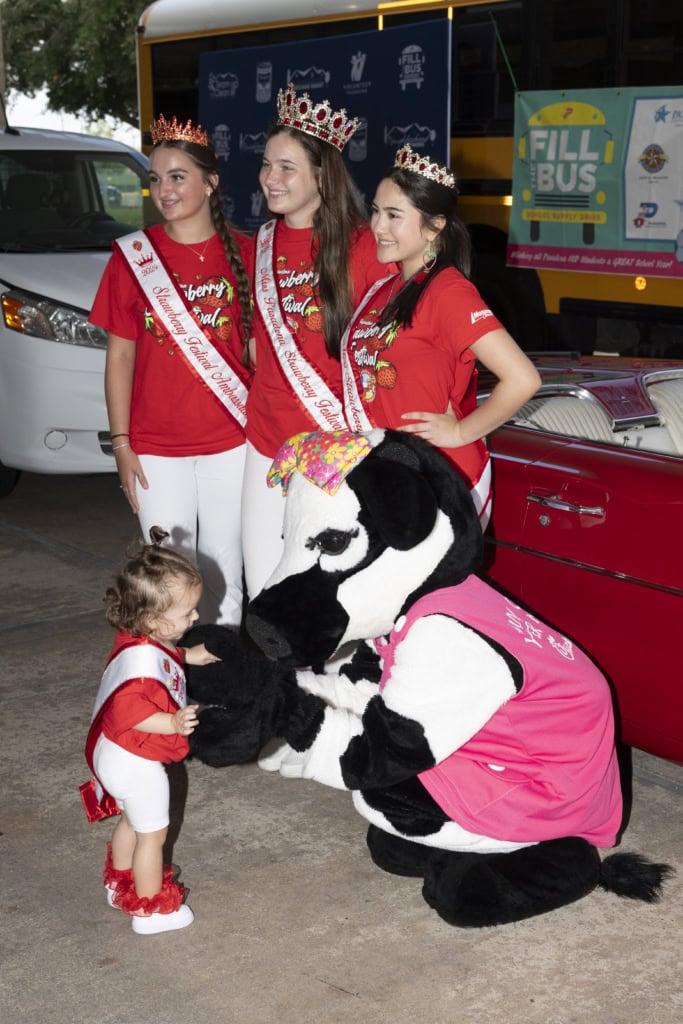 A group of teenage girls, the Strawberry Queens, poses for Pasadena's Fill the Bus drive.