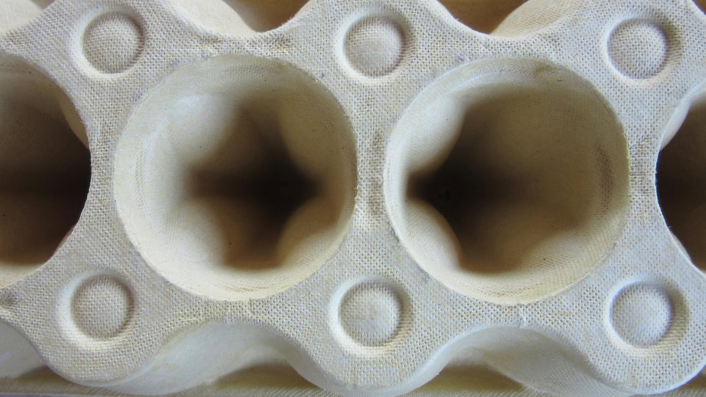 A close-up image of an egg carton shows paperization in action in molded fiber products.